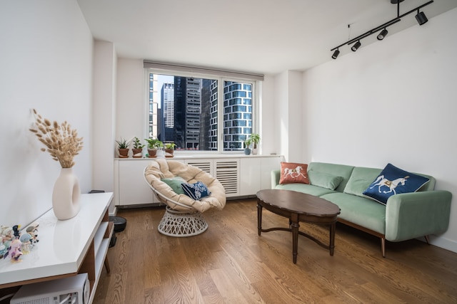 sitting room with hardwood / wood-style floors and rail lighting