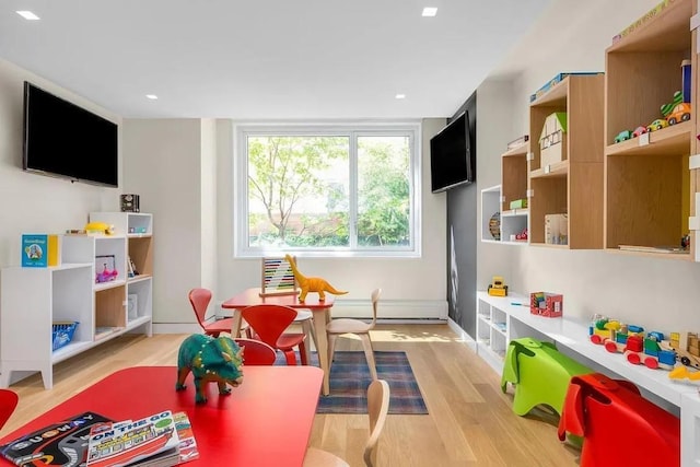 game room with light hardwood / wood-style floors