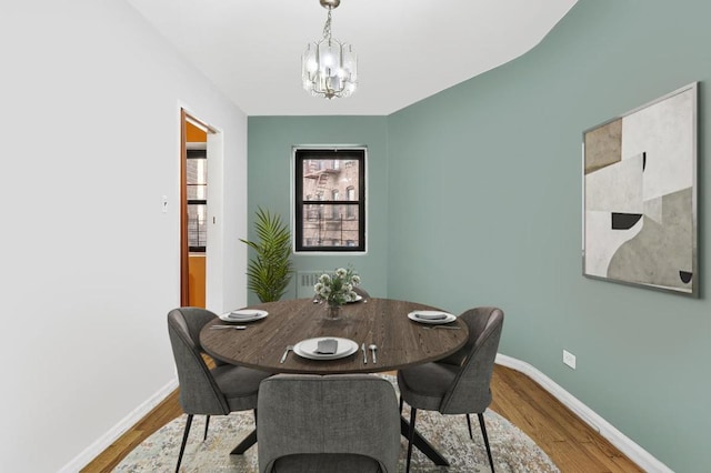 dining room featuring an inviting chandelier and wood-type flooring