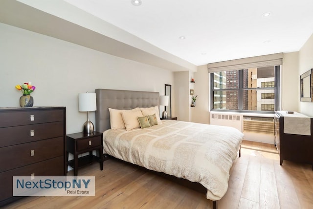 bedroom with recessed lighting and wood finished floors