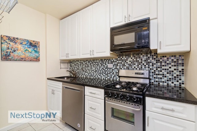 kitchen featuring a sink, appliances with stainless steel finishes, white cabinets, and tasteful backsplash
