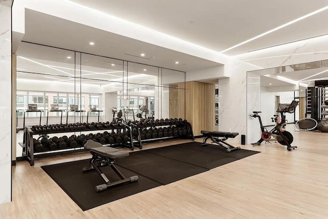 workout area with hardwood / wood-style floors