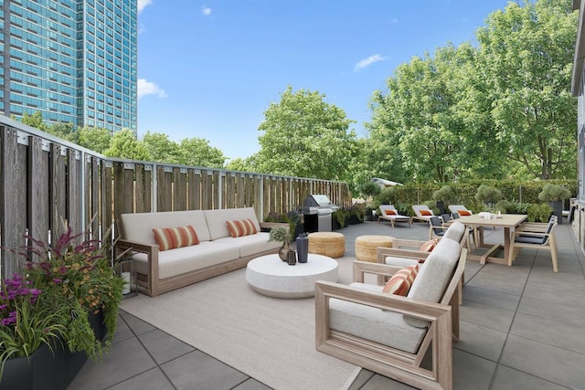 view of patio / terrace featuring outdoor dining space, grilling area, outdoor lounge area, and a fenced backyard