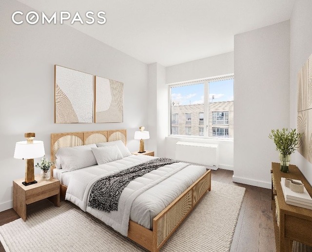 bedroom featuring hardwood / wood-style flooring and radiator heating unit