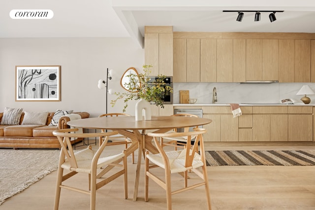 kitchen featuring light countertops, modern cabinets, light brown cabinets, and visible vents