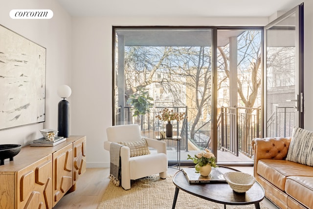 living room featuring light wood-type flooring, baseboards, and visible vents