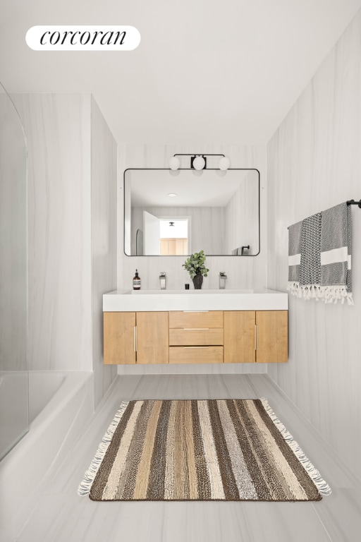 bathroom with vanity and bathtub / shower combination