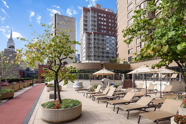 view of community with a view of city and a patio area