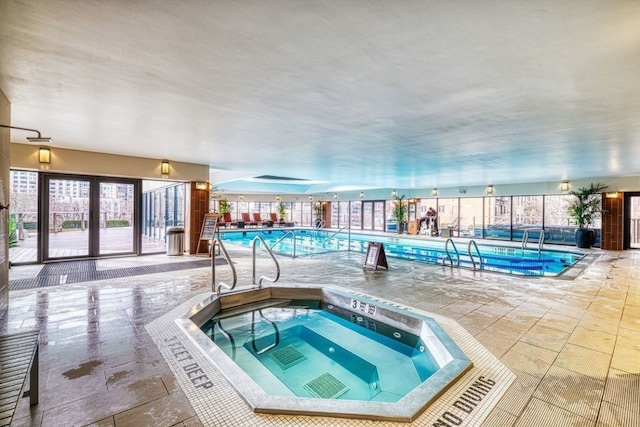 view of pool with an indoor in ground hot tub and a patio