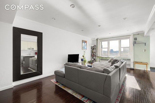 living room with dark wood-style floors, ornamental molding, and baseboards