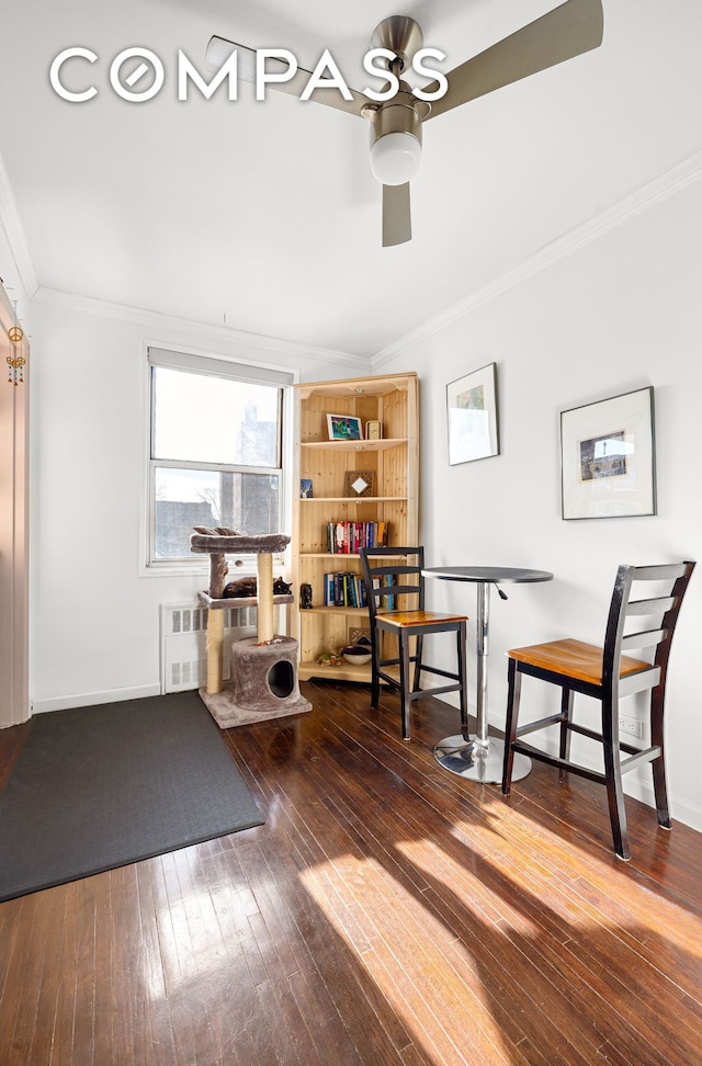 interior space with baseboards, radiator heating unit, ornamental molding, and hardwood / wood-style floors