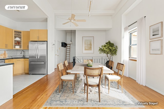 dining space with ceiling fan, sink, and light hardwood / wood-style flooring