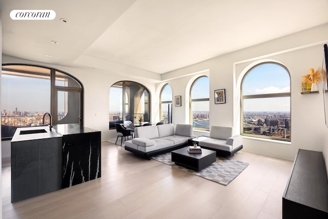 living area featuring light wood-style flooring, recessed lighting, and visible vents