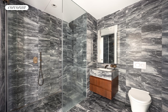 full bathroom with toilet, vanity, walk in shower, marble finish floor, and tile walls