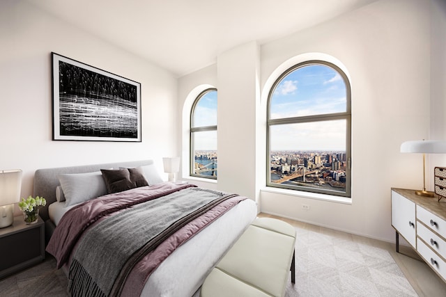 bedroom with baseboards and light colored carpet