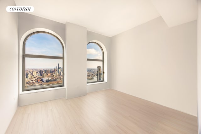 spare room featuring visible vents and wood finished floors