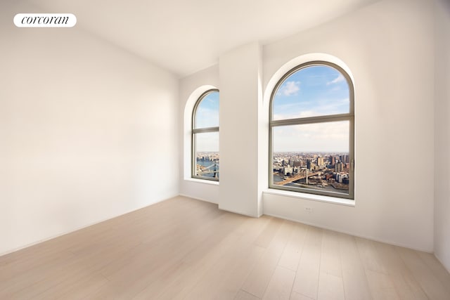 spare room with wood finished floors and visible vents
