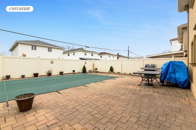 view of swimming pool featuring outdoor dining space, a patio, a fenced backyard, and a grill