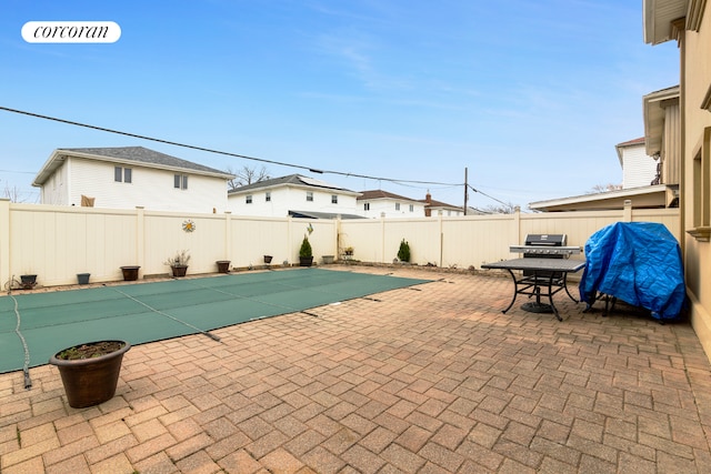 view of swimming pool featuring a grill and a patio area