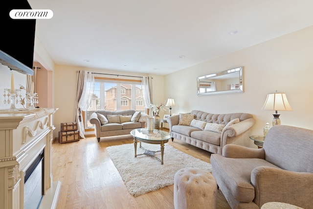 living room with light wood-type flooring and recessed lighting