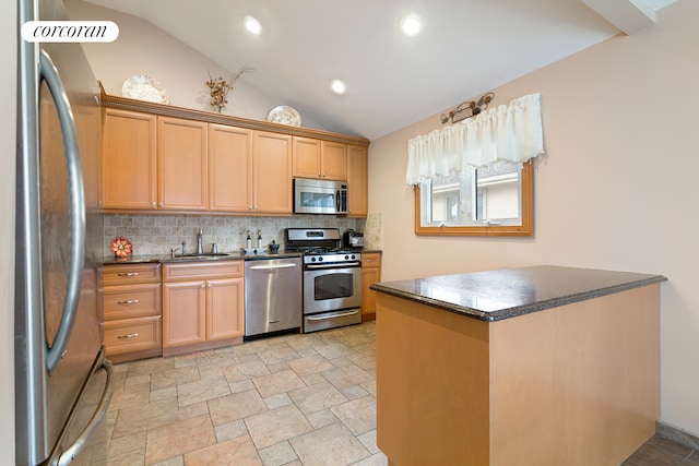 kitchen with stone finish flooring, a sink, lofted ceiling, stainless steel appliances, and decorative backsplash