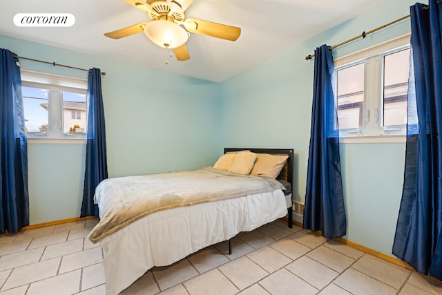tiled bedroom with baseboards, a ceiling fan, and visible vents