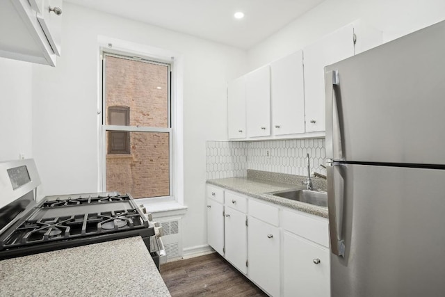 kitchen featuring dark wood-type flooring, appliances with stainless steel finishes, sink, and white cabinets