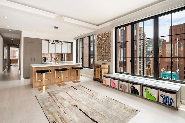 kitchen featuring baseboards, light countertops, modern cabinets, and a healthy amount of sunlight