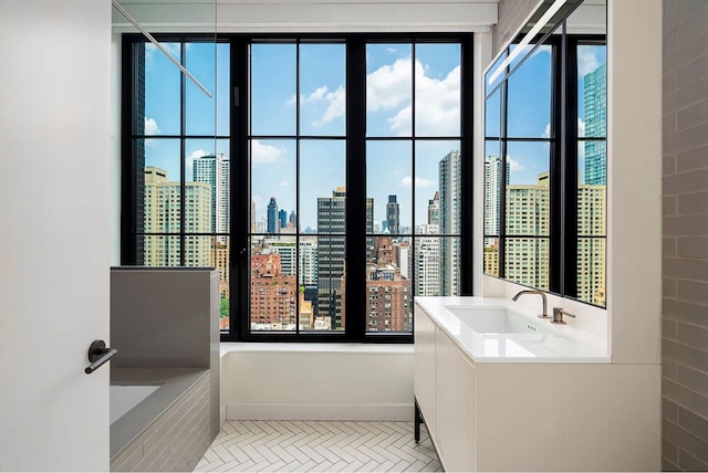full bathroom with a healthy amount of sunlight, a view of city, vanity, and a garden tub