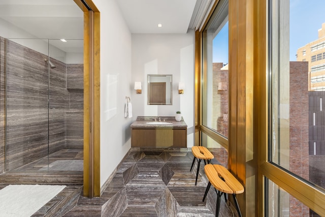 bathroom with vanity and a tile shower