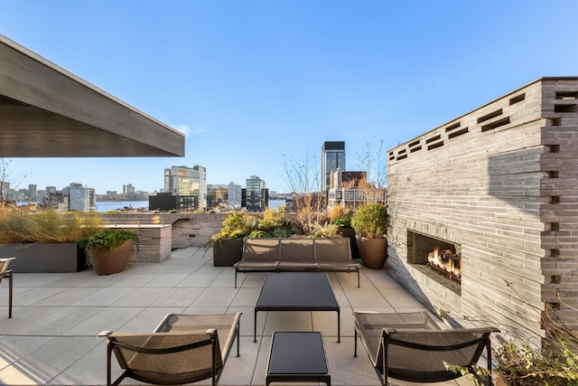 view of patio with an outdoor brick fireplace