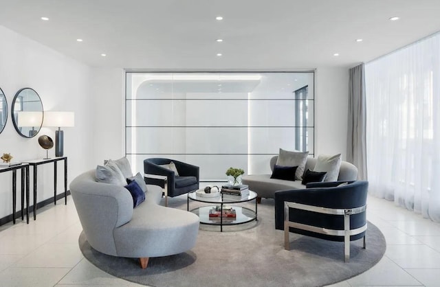 living room featuring a wall of windows, light tile patterned floors, and recessed lighting