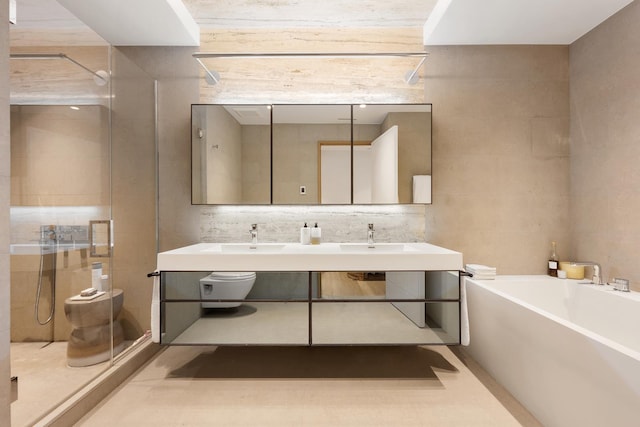 full bath featuring tile walls, a shower stall, vanity, and a bath