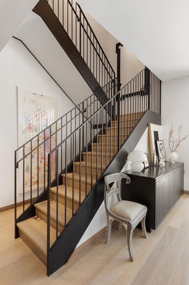 stairs with baseboards and wood finished floors