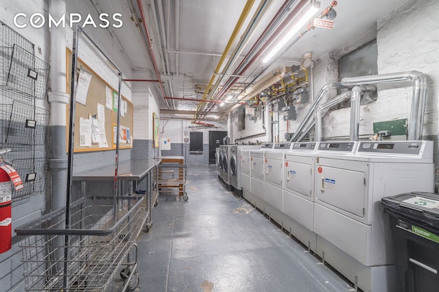 basement featuring electric panel and washing machine and dryer