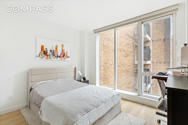 bedroom with wood finished floors and baseboards