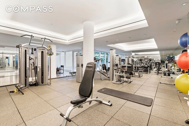 exercise room featuring a raised ceiling