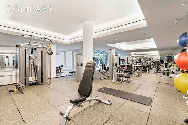 workout area with a raised ceiling