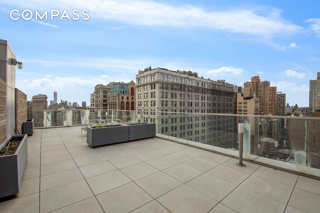 view of patio featuring a view of city and a balcony