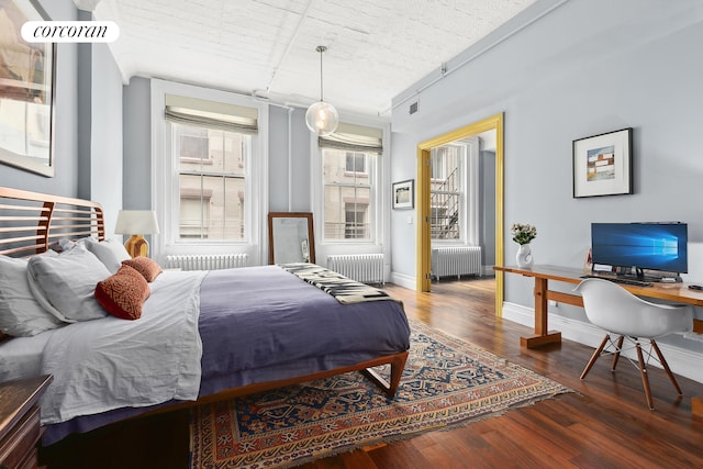 79 Worth St Unit 4R, New York City, NY 10013 - bedroom featuring radiator, wood finished floors, and an office area
