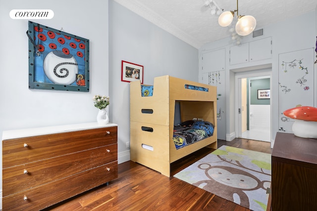 79 Worth St Unit 4R, New York City, NY 10013 - bedroom featuring a chandelier, wood finished floors, and baseboards