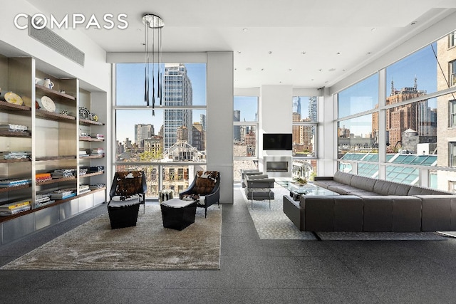 living room with expansive windows, a healthy amount of sunlight, and built in features