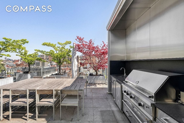 view of patio / terrace featuring area for grilling, sink, and exterior kitchen