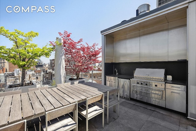 view of patio featuring grilling area, exterior kitchen, and sink