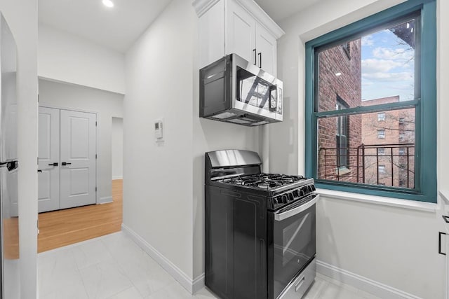 kitchen featuring appliances with stainless steel finishes and white cabinets