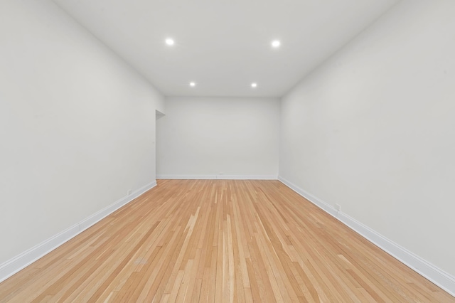 empty room with recessed lighting, baseboards, and light wood finished floors