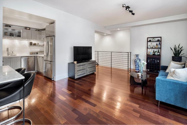 living room with dark hardwood / wood-style flooring and sink