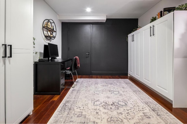 home office with dark hardwood / wood-style floors