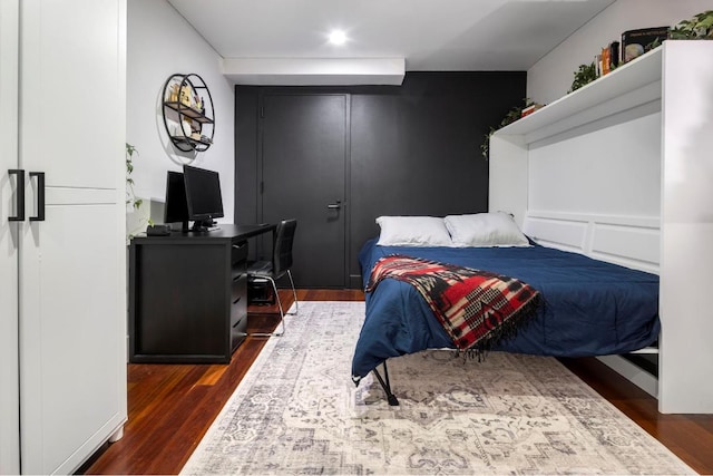 bedroom with dark hardwood / wood-style floors