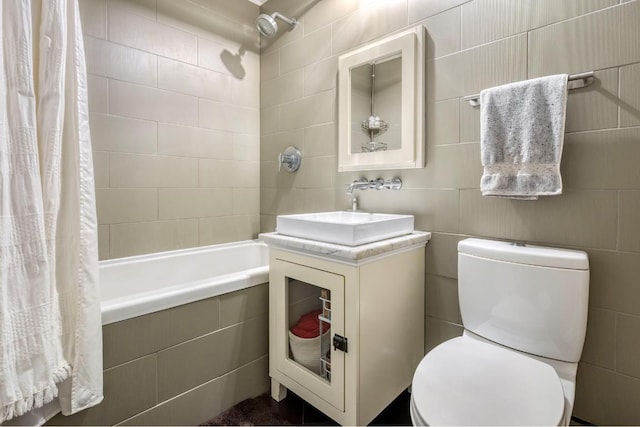 full bathroom with toilet, sink, shower / bath combo with shower curtain, and tile walls